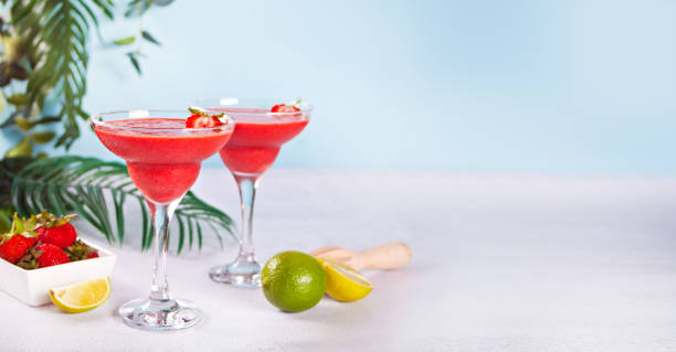 Cold strawberry margarita or daiquiri cocktail with lime and rum stock photo