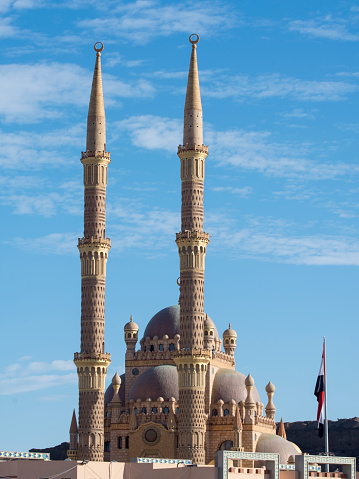 Al-Sahaba mosque in Sharm El Sheikh. Two minarets on blue sky background. Muezzin calls Muslims to prayer, adhan.