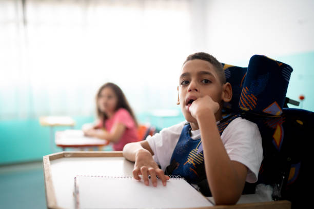 istock Portrait of a boy with special needs in the classroom 1367330160