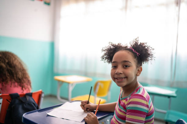 istock Portrait of a girl taking notes in the classroom 1367330168