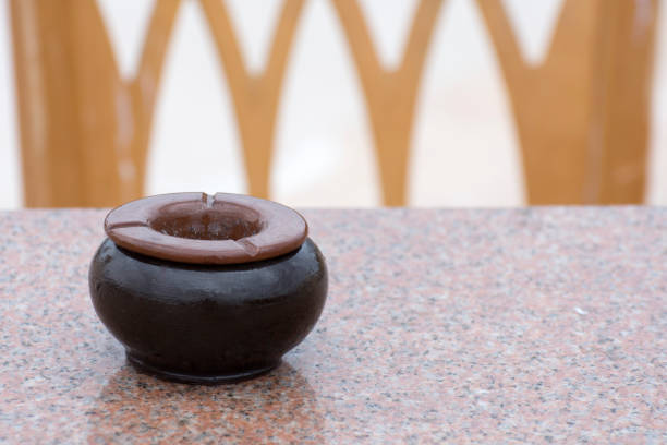 Clay arabic ashtray on an empty table in a cafe. No visitors, place for smoking. Copy space.