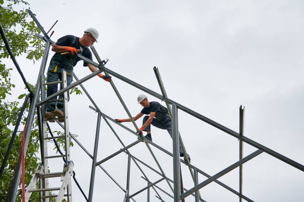 istock Male workers installing metal poles and rails for solar panels. 1367331391