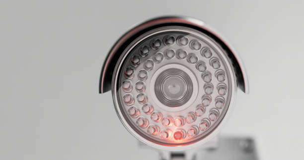 istock Surveillance camera in close- up on a white background 1367332514
