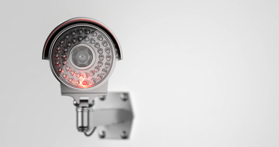 Modern security camera with an infrared ray inserted in it from the front side in close up on a withe background