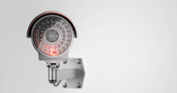 Modern security camera from the front side in close up on a withe background Modern security camera with an infrared ray inserted in it from the front side in close up on a withe background big brother orwellian concept stock pictures, royalty-free photos & images