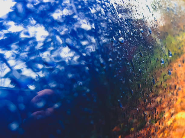 A blue lacquered metal covered with raindrops.