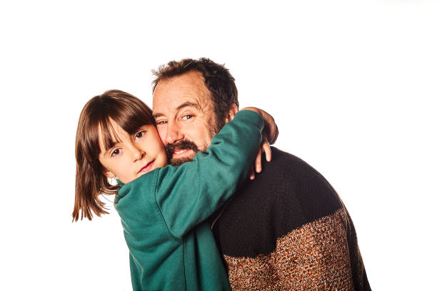 istock happy daughter hugging her father on an isolated white background on Father's Day 1367334209