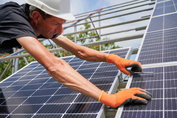 istock Male worker installing photovoltaic solar panel outdoors. 1367335206