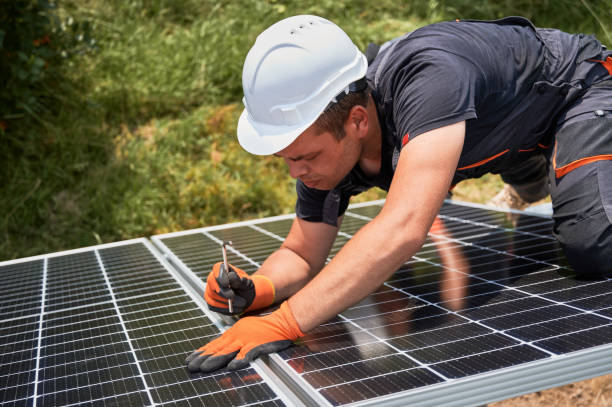 istock Male worker mounting photovoltaic solar panel system outdoors. 1367335249