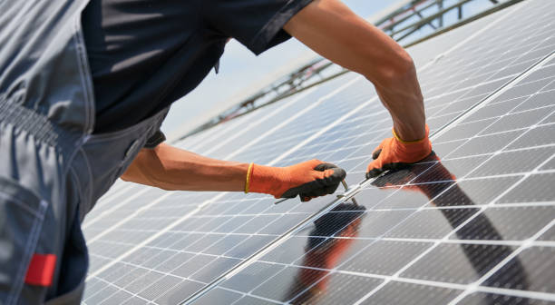 istock Male worker hands installing solar panels outdoors. 1367335260
