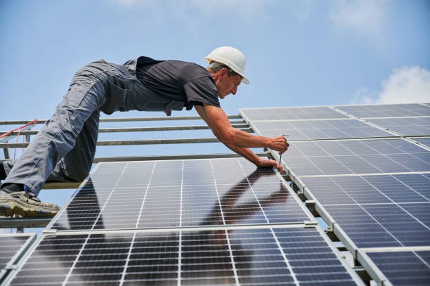 istock Male worker mounting photovoltaic solar panel system outdoors. 1367335312