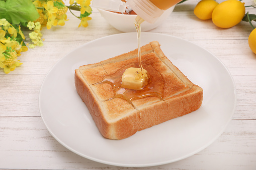 The image that served the honey butter toast which I sprinkled plentiful honey to a dish.