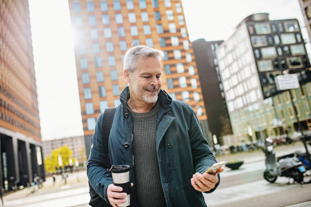 istock Mature businessman commuting and using smart phone 1367336133
