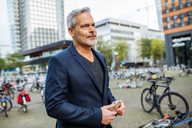 istock Mature businessman commuting and using smart phone 1367336493