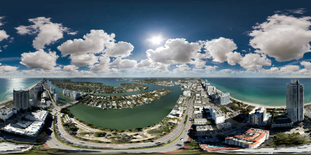 istock Aerial 360 equirectangular panorama Miami Beach scene with puffy clouds in sky 1367336905