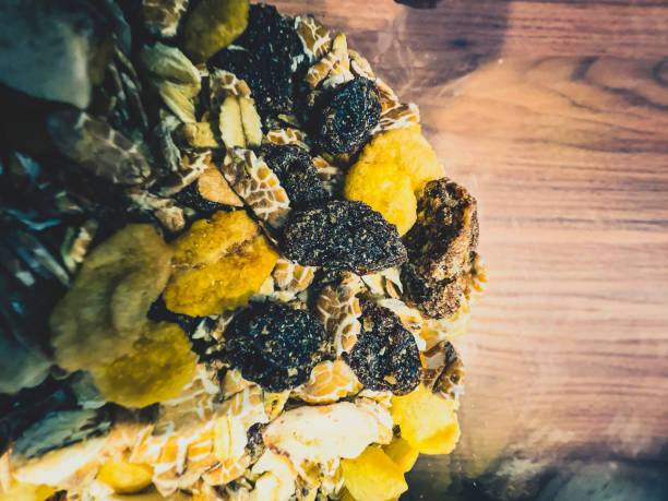 View into a glass container with cereal on a wooden table.