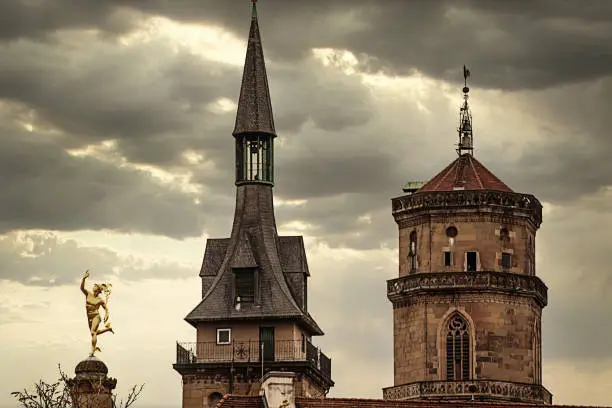 Stuttgart, Germany -  City center skyline with the golden Hermes statue and the medieval and Romanesque towers of the Stiftskirche  (Collegiate Church)