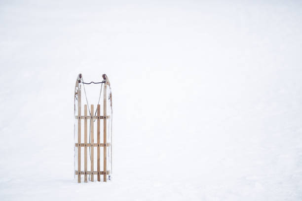 Sled stuck in a snow pile. Front first the sled is wedged into the snow. Winter scene. Snow fun.