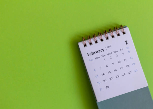 istock Desktop calendar for February 2022 on a green background. 1367340753