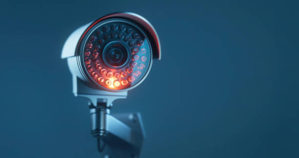 istock CCTV camera on a mate blue background with a copy space in close up 1367341657