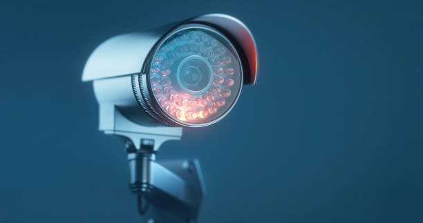 istock CCTV camera on a mate blue background with a copy space in close up 1367341662