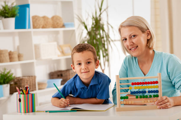 Math time Mother assisting her son to count using an abacus Online Montessori Training stock pictures, royalty-free photos & images