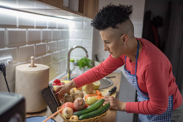 istock Woman cutting vegetables at the kitchen 1367341986