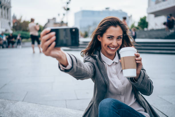 Young woman making selfie outdoors.