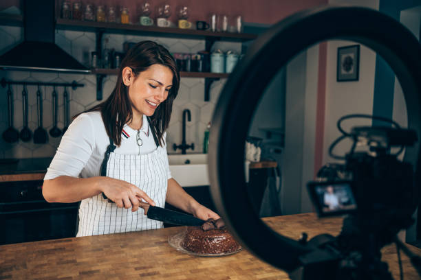 istock Cheerful woman recording vlog about cooking. 1367342087