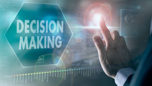 istock A businessman controlling a futuristic display with a Decision Making concept on it. 1367343353