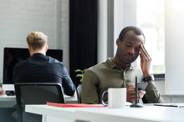 istock Tired afro american man having a headache 1367343550