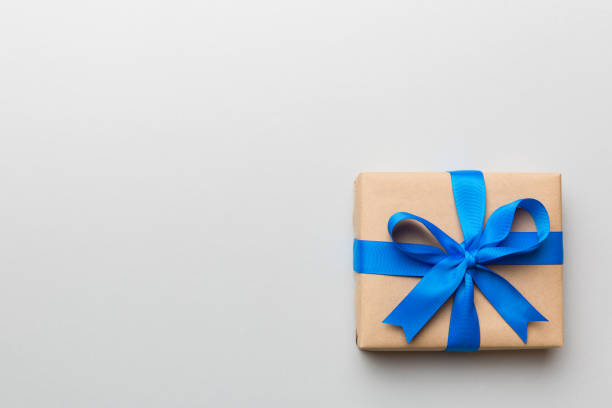 istock Holiday present box over colored background, top view. Copy space for design 1367343950