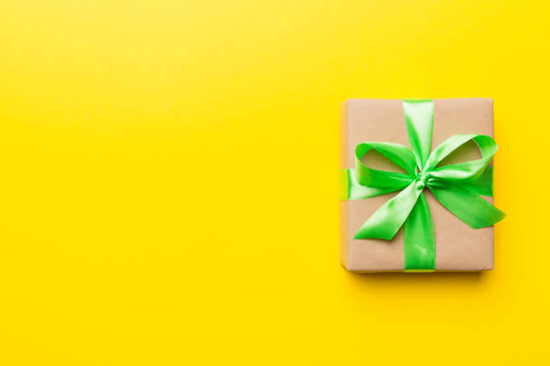 istock Holiday present box over colored background, top view. Copy space for design 1367343951