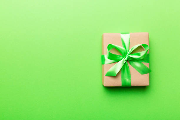 istock Holiday present box over colored background, top view. Copy space for design 1367343979