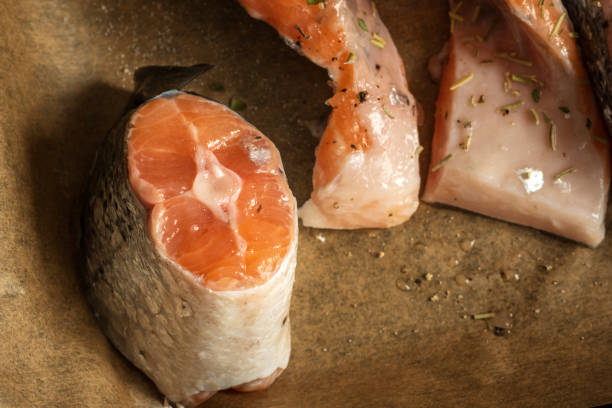 istock raw salmon filets with herbs and spices on baking tray 1367346588