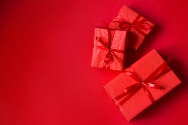 istock Red Valentine's Day background. Red gift boxes with red ribbon, empty space for text. Background for sales, advertising, greeting cards 1367348484