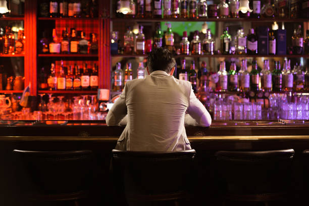 istock Back view of a young man drinking beer 1367352675