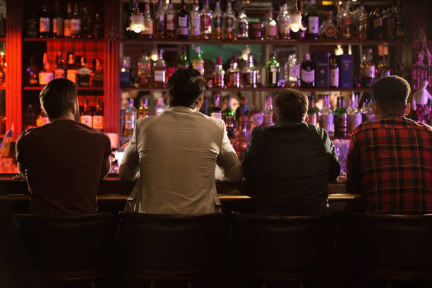 istock Back view of four young men drinking beer 1367352845