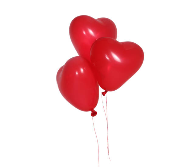 istock Two Romantic  red heart-shaped balloons isolated on white background. 1367353412