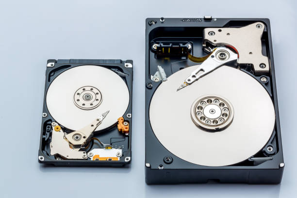 istock Hard disk drive and open cover. Computer hardware, hard disk, storage device. Detail of the inside of a hard disk drive. Hard disk is internal mechanism hardware 1367355079