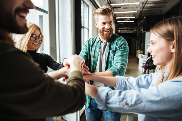istock Colleagues in office holding hands of each other 1367356313