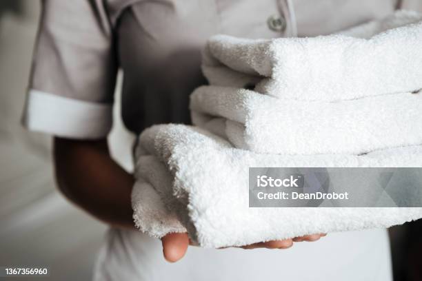 Close Up Of A Young Maid Holding Folded Towels Stock Photo - Download Image Now - Housekeeping Staff, Hotel, Housework