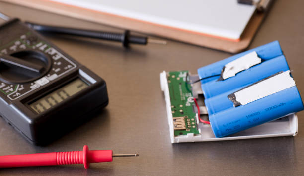 istock red polymeter work table. in the background multimeter and powerbank with blu batteries mod 18650 1367358229