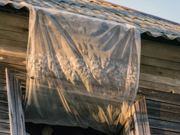 istock old wooden window, beautiful lace decor in the window 1367358506