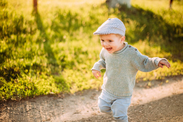 istock Cute and handsome baby boy 1-2 years old exploring nature in summer, having fun 1367359407