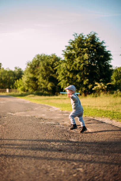 istock Cute and handsome baby boy 1-2 years old exploring nature in summer, having fun 1367359410