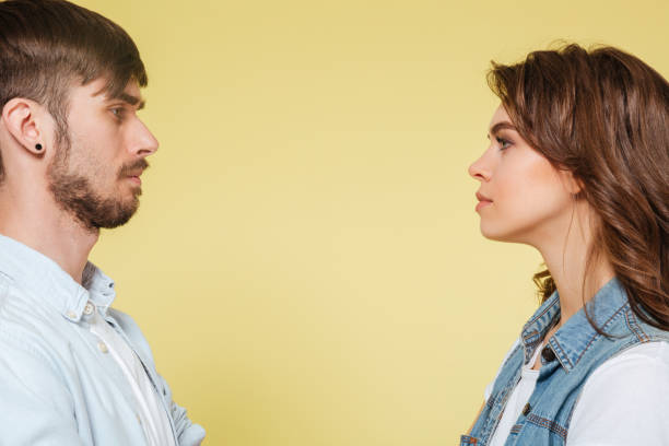 istock Serious brother and sister looking at each other 1367359622