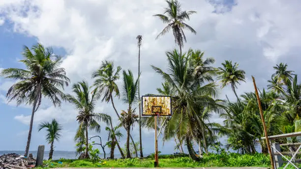 Photo of Abandoned basketball field with rust on the basket board.