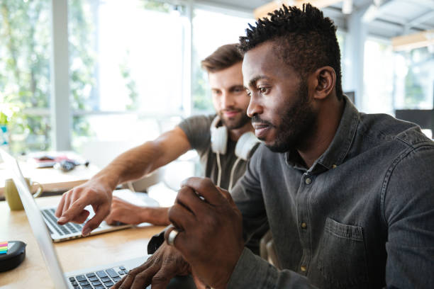 istock Concentrated young colleagues sitting in office coworking 1367361667