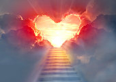 istock Stairway to Heaven.Stairs in sky.  Concept with sun and clouds.  Religion  background. Red heart shaped sky at sunset. Love background with copy space. 1367361683